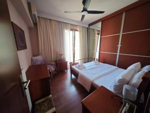 a hotel room with a bed and a window at Red House Retreat Aegina Kontos in Kondós