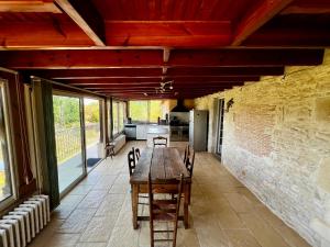 a large dining room with a table and chairs at La Maison de Renée in Sainte-Eulalie-dʼAns