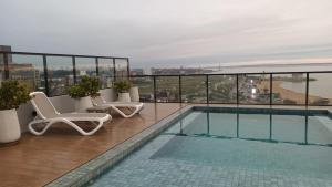 a swimming pool on the roof of a building at LUXER VIVO Encarnacion in Encarnación +14 photos