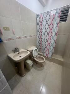 a bathroom with a toilet and a sink at Apto Próximo al Aeropuerto Gregorio Luperón in Puerto Plata +19 photos