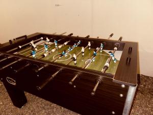 a miniature football game in a wooden box at Sweet Home JACÓ in Herradura