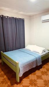 a bedroom with a bed with a blue blanket at Sweet Home JACÓ in Herradura +5 photos