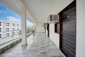 a corridor of a building with a door and a balcony at Hotel O Moonlight Residency in Noida