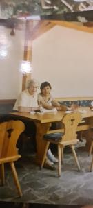 two people sitting at a table in a room at Gasthaus Korfu in Edenkoben +9 photos