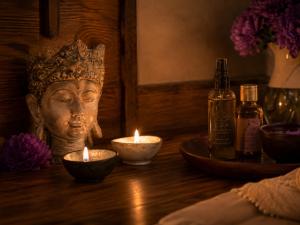 a statue of a head with candles on a table at Hunza Longevity Resort in Eskiömerler