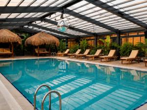 a swimming pool with lounge chairs and a resort at Hunza Longevity Resort in Eskiömerler