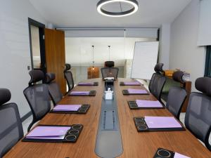 a conference room with a long table and chairs at Hunza Longevity Resort in Eskiömerler +29 photos