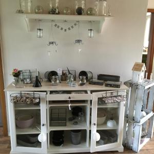 a doll house kitchen with a counter top and shelves at Pension Panorama in Hitzacker