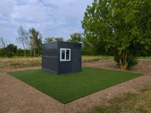 a tiny house on a patch of green grass at Chatka U Rybičky in Babice