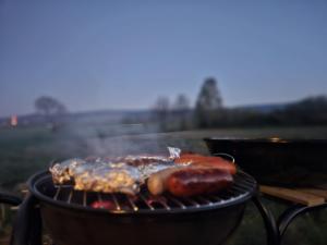 two hot dogs are cooking on a grill at Przystań Vianneya in Giebułtów
