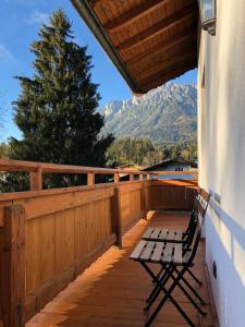 a bench on a porch with a view of a mountain at Haus Widmann in Scheffau am Wilden Kaiser