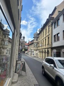 a car parked on the side of a street with buildings at Sierra Ferienwohnung in Marktbreit +1 photo