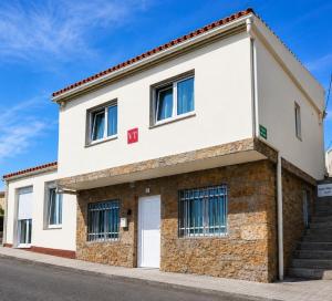 a white building with a red roof at Casa Marzoa in Finisterre