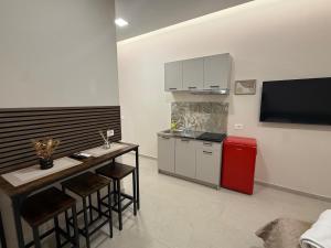 a kitchen with a counter and a red refrigerator at La Vista Suite and Rooms in Ladispoli