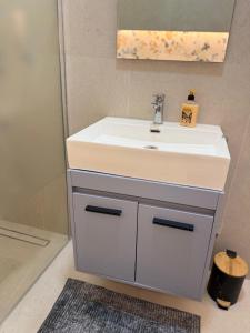 a bathroom with a white sink and a mirror at La Vista Suite and Rooms in Ladispoli +62 photos