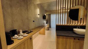 a bathroom with a sink and a counter with a sink at Elegance Suites in Pyrgos +35 photos