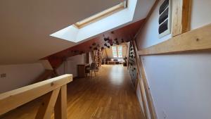 an attic hallway with a skylight in a house at PARADAJS City Center Apartments - 24h self check-in & free private parking in Spišská Nová Ves