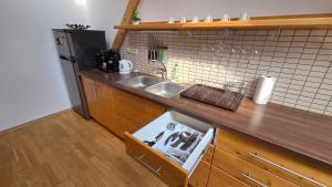 a kitchen with a sink and a counter top at PARADAJS City Center Apartments - 24h self check-in & free private parking in Spišská Nová Ves