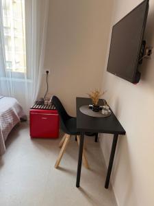 a black desk with a television on a wall at La Vista Suite and Rooms in Ladispoli