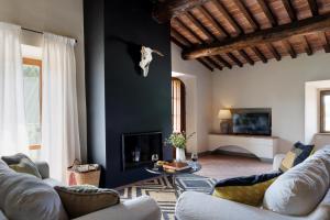 a living room with two couches and a fireplace at Agriturismo Piettorri in Casole dʼElsa