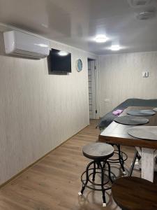 a room with tables and chairs and a tv on the wall at Дача у моря-2 in Vapnyarka