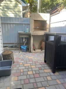a patio with a table and a table and a grill at Дача у моря-2 in Vapnyarka