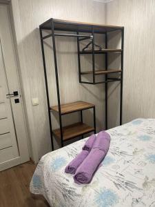 a bed with a purple towel on top of it at Дача у моря-2 in Vapnyarka