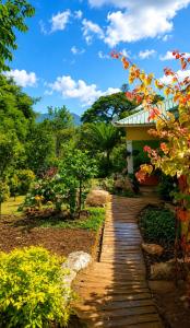 a walkway leading to a house in a garden at Naisi spur in Zomba