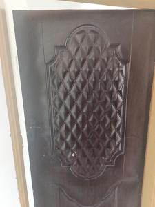 a wooden door with a design on it at Chimwemwe apartments in Chingola