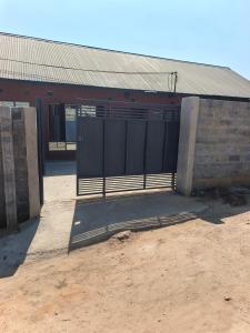 a gate in front of a brick building at Chimwemwe apartments in Chingola