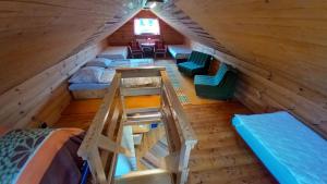 an overhead view of a attic with beds and a ladder at Chata Milka in Medzilaborce
