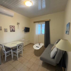 a living room with a couch and a table at Saint Giovanni House in Kharokopión