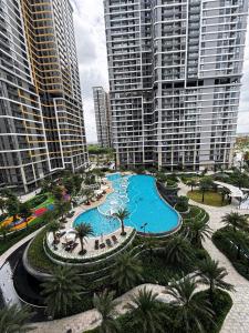 an aerial view of a pool in a city with tall buildings at The Opus One 1 in Long Bình