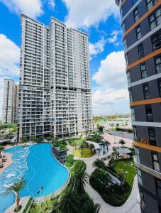 a view of a large apartment building with a swimming pool at The Opus One 1 in Long Bình