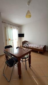 a room with a table and chairs and a bed at A&A Aparthotel in Orikum +16 photos