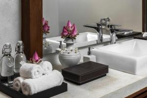 a bathroom counter with a sink and a mirror at Jaya House River Park in Siem Reap