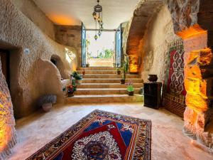 a hallway with stairs and a rug on the floor at Memories Cave House in Uçhisar
