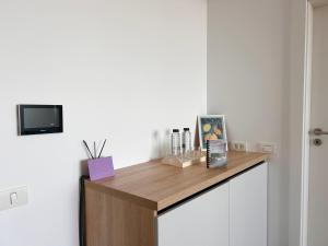 a room with a wooden counter with a tv on a wall at V'One - Cozy & Quiet Apartment - Free Parking in Timişoara