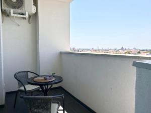 a small table and chairs in a room with a window at V'One - Cozy & Quiet Apartment - Free Parking in Timişoara
