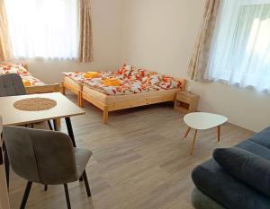 a small living room with a bed and a couch at Ubytování Krucemburk in Křížová