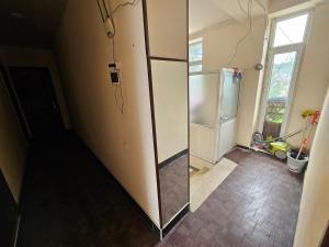 a kitchen with a refrigerator in a room at Oscar Hotel Guba in Quba