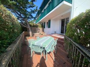 a wooden deck with a table and chairs on a house at Maison basque familiale Eguski Alde in Saint-Jean-de-Luz