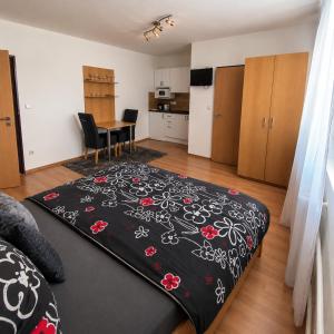 a living room with a black blanket on the floor at Apartmánový dom Adriana in Zuberec +12 photos