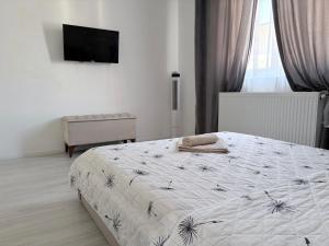 a bedroom with a bed and a television in it at Bella Home Residence in Roşu
