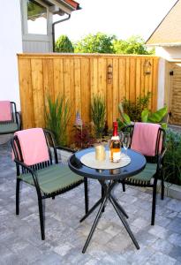 a patio with a table and chairs and a bottle of beer at Apartment -Zur Oehla in Ilmenau