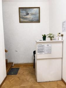 a room with a white wall with a picture on the wall at Green Hostel in Yerevan