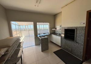 a large kitchen with a fireplace in a room at Alojamiento Center in Barraquero +5 photos