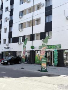 a building with a car parked in front of it at Bella Home Residence in Roşu