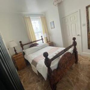 a bedroom with a bed with a wooden frame at Alexander's luxury rooms all en-suite, spa bath in Blackpool