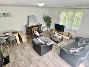 a living room with two couches and a fireplace at Chaloupka Všemily in Jetřichovice